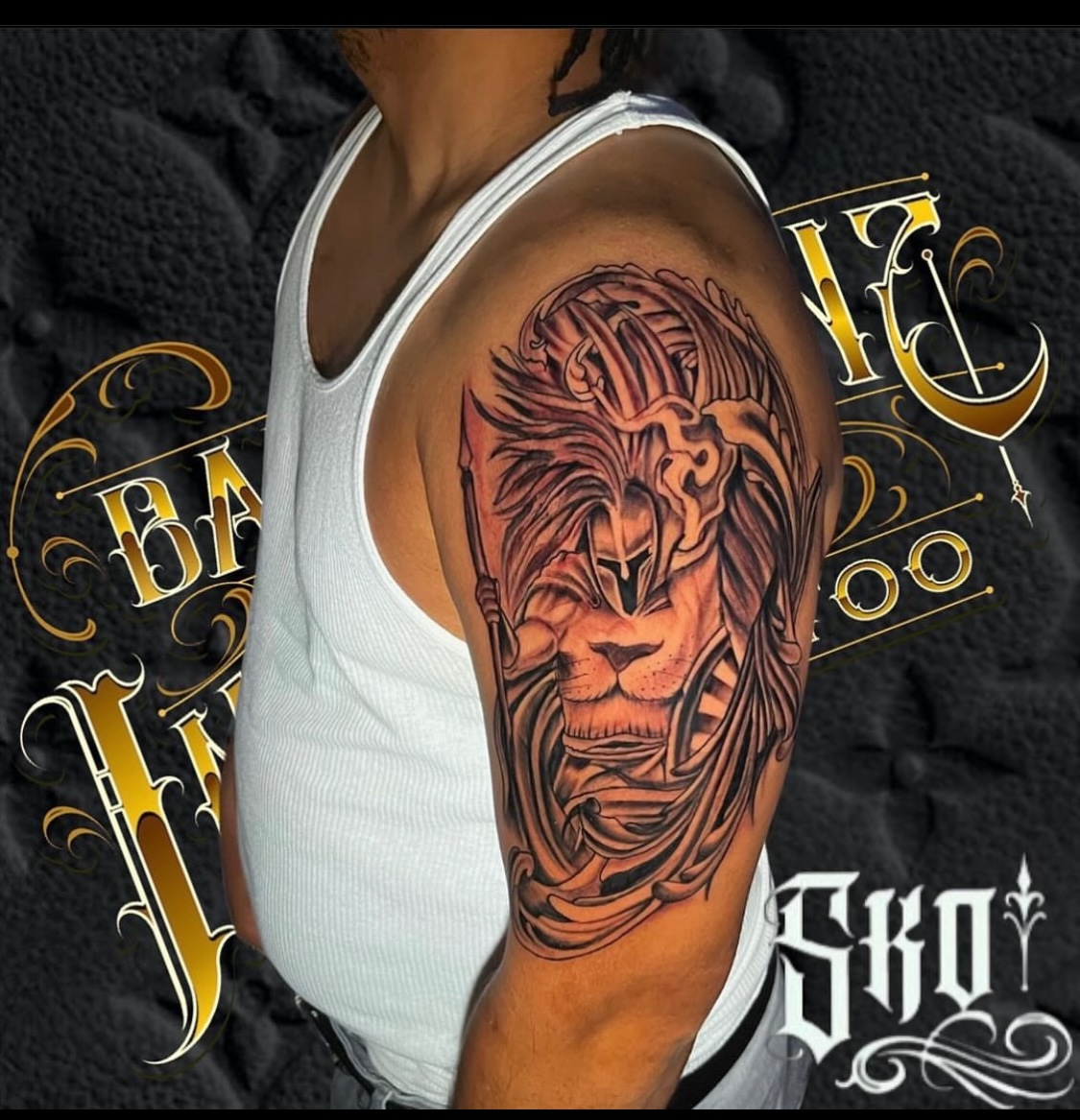 Black and grey lion in a Spartan helmet half-sleeve tattoo by Bad Intentionz Tattoo, Bloomfield NJ